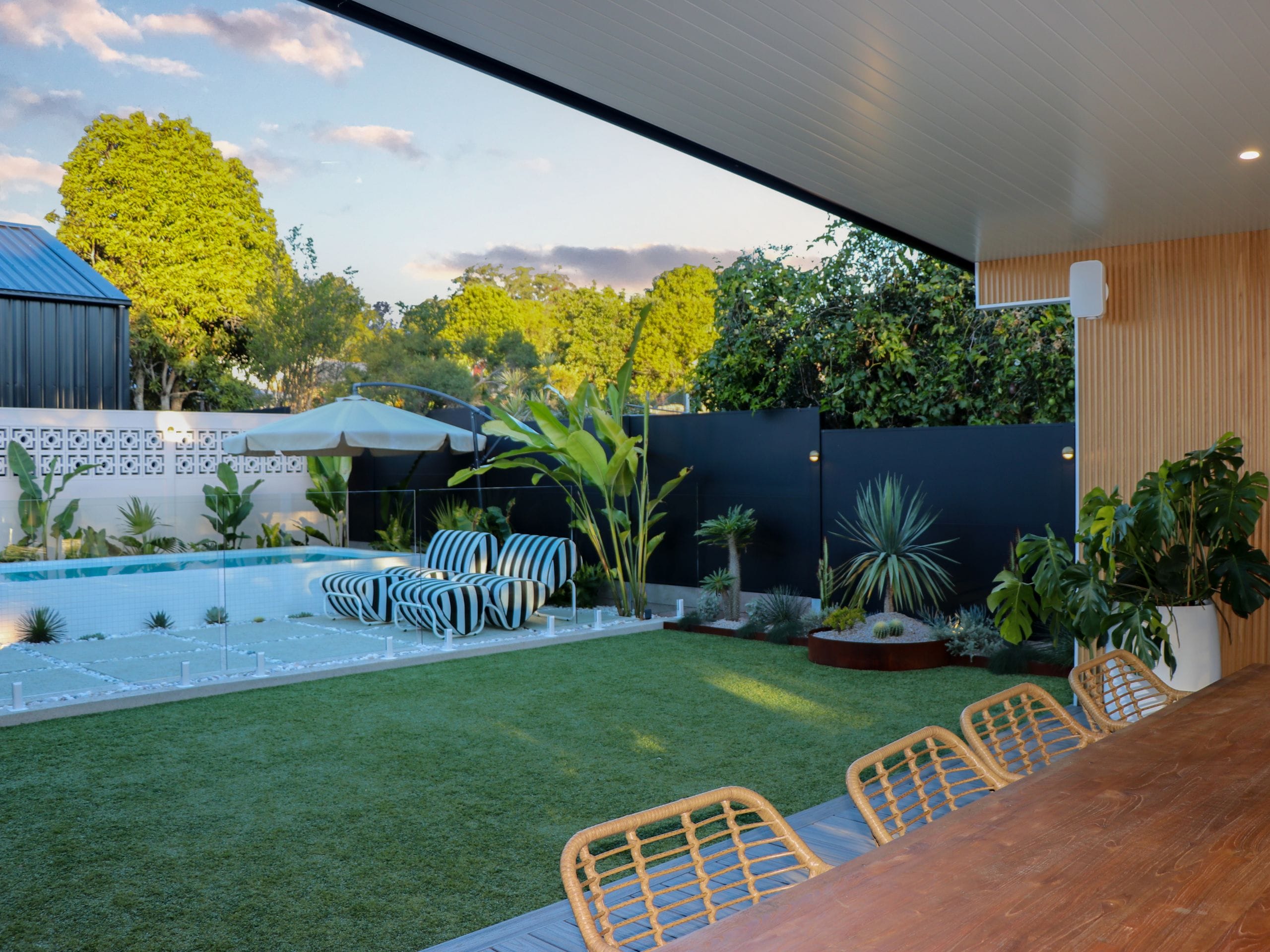 Jimmy & Tam's backyard includes a pool, lawn and outdoor kitchen and dining.