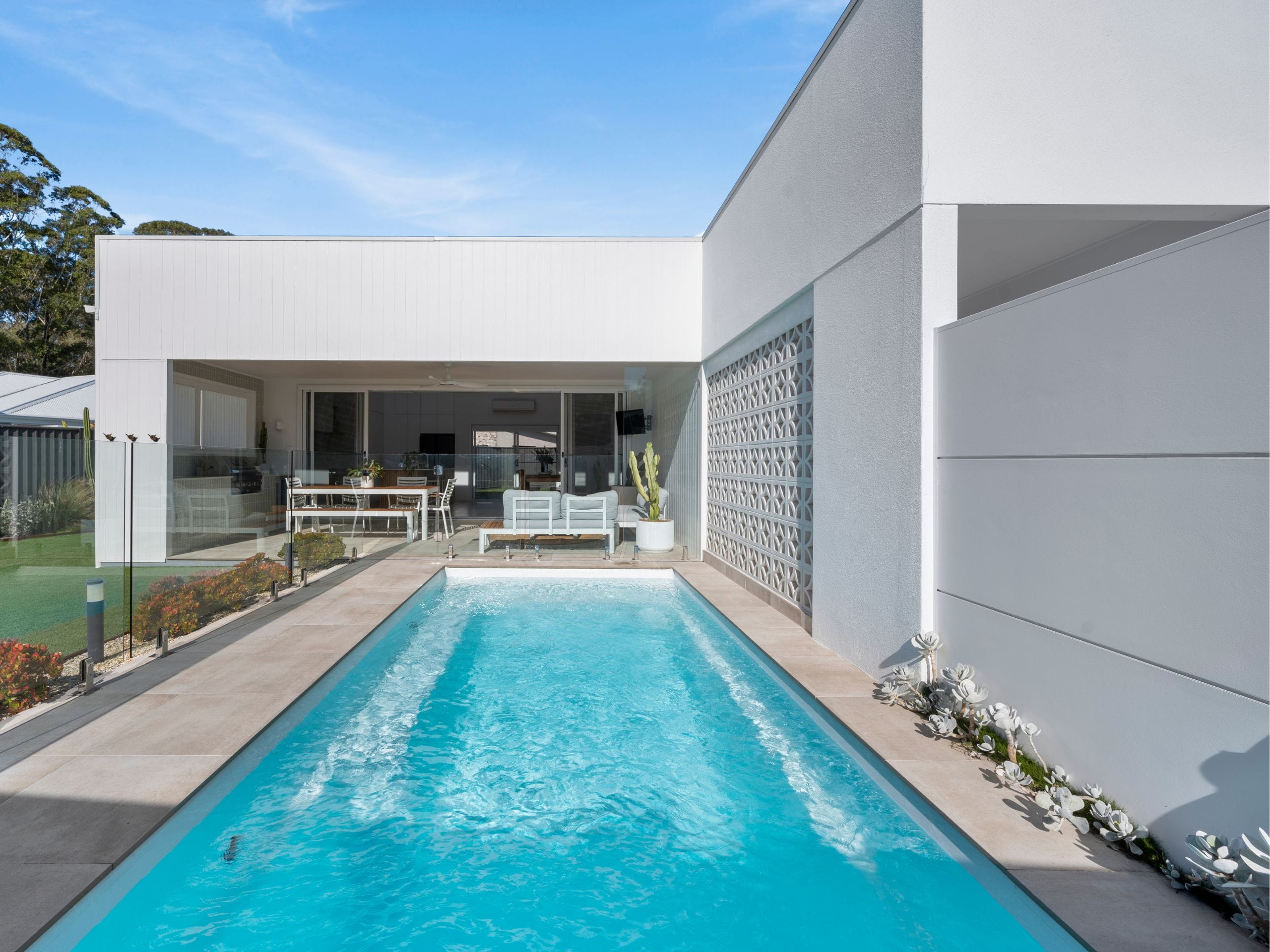 Minimalist pool to frame the geometric shapes of the home's facade