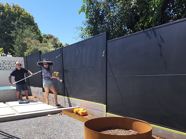 Jimmy and Tam completing a DIY installation for their backyard renovation