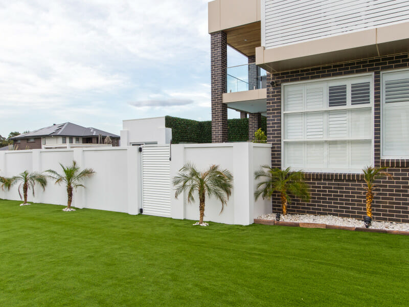 Corner Block Fencing with EstateWall including external wall capping and gate create privacy for the yard.