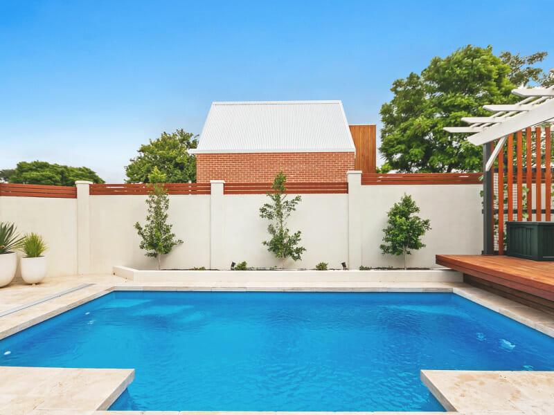 Holiday DIY projects - rejuvenate your back yard with a VogueWall pool and boundary fence like this. VogueWall with external post caps and slats.