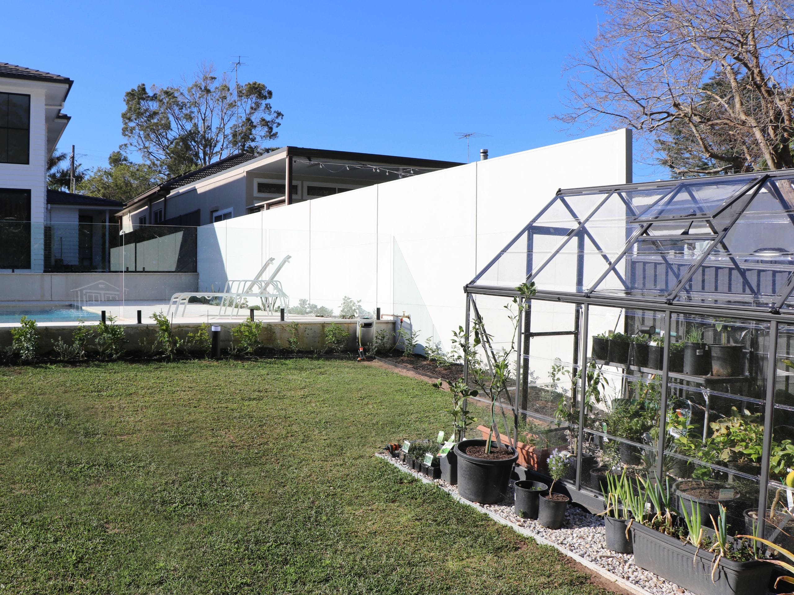 A greenhouse is a simple, effective DIY garden idea to protect plants in autumn and winter