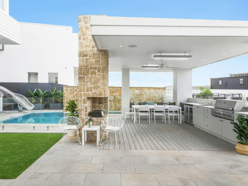 Outdoor Kitchen and dining area with privacy created with a SlimWall pool wall