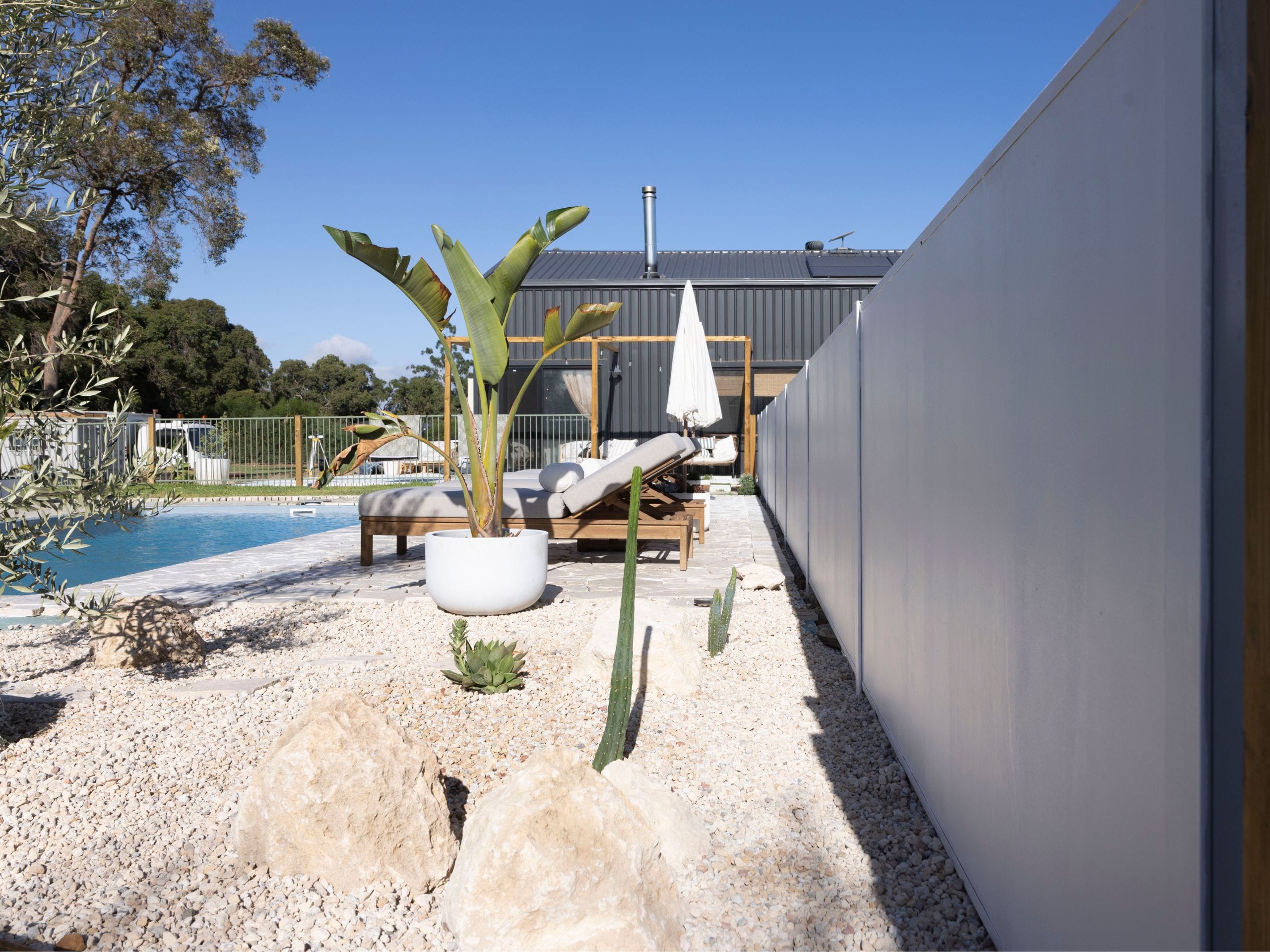 Lauren and Louis embraced a simple approach at their Jersey Road home, combining their DIY SlimWall® pool fence with gravel and sculptural planting. Their project demonstrates how a considered backdrop and a few complementary materials can create a cohesive result.