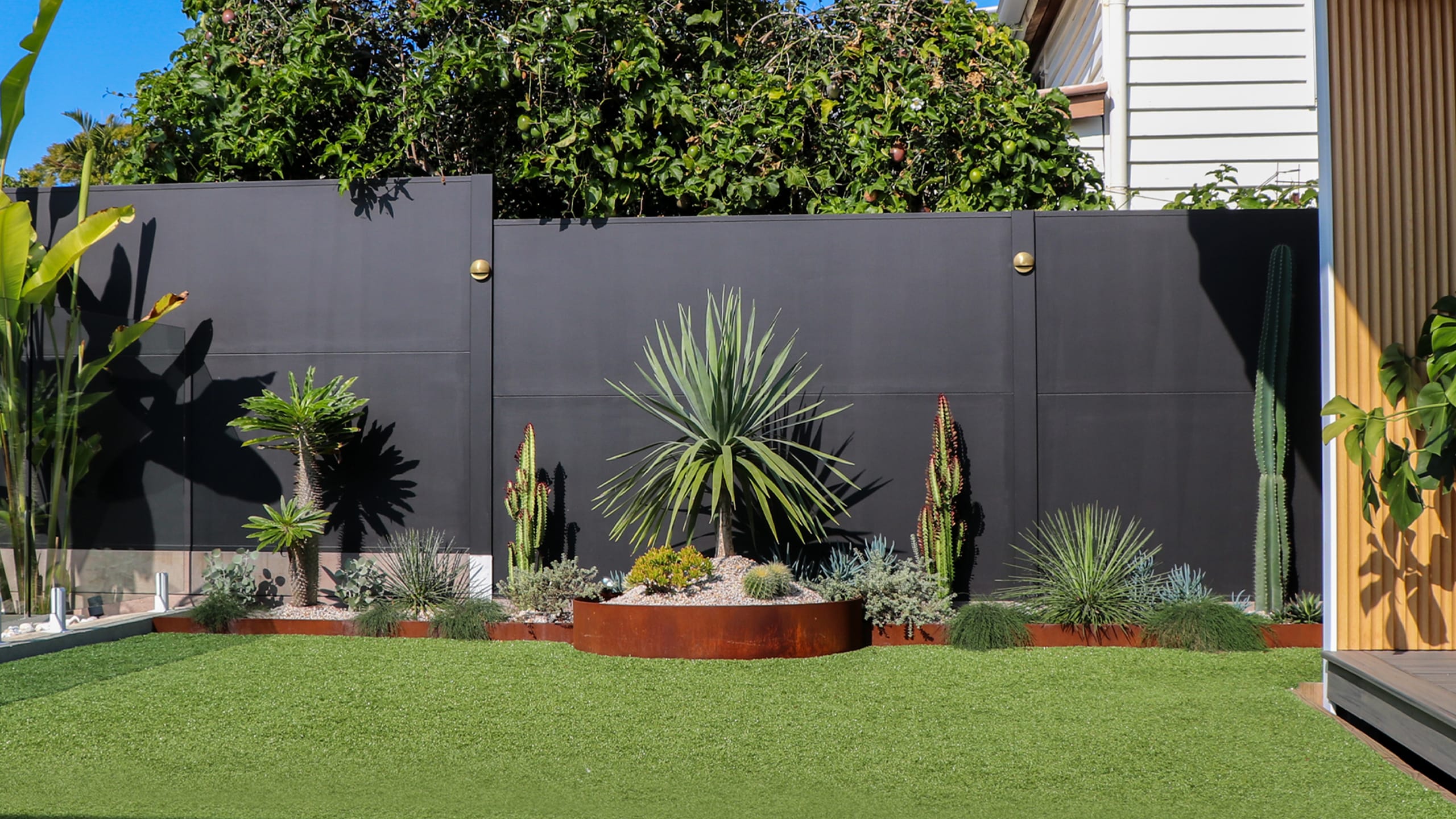 Jimmy & Tam - Winners of The Block. DIY TrendWall boundary fence painted black with integrated lighting.