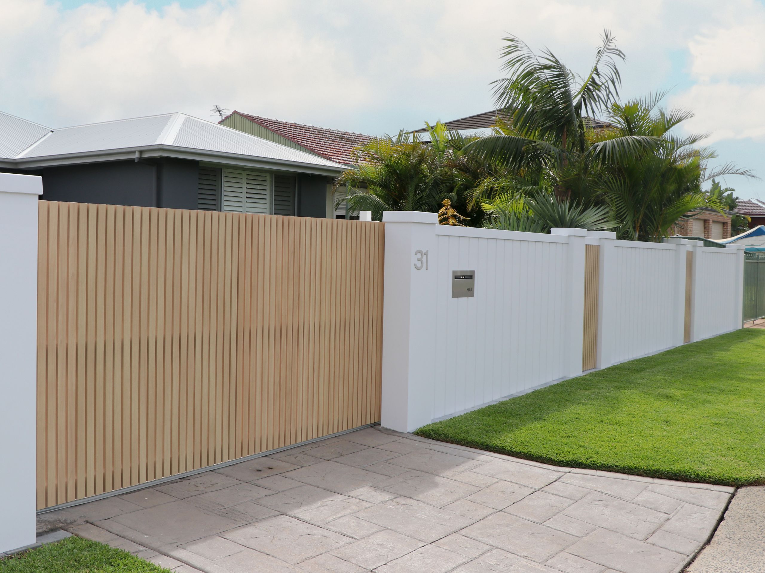 A modern coastal and beachy landscaping aesthetic is achieved using a customised EstateWall 