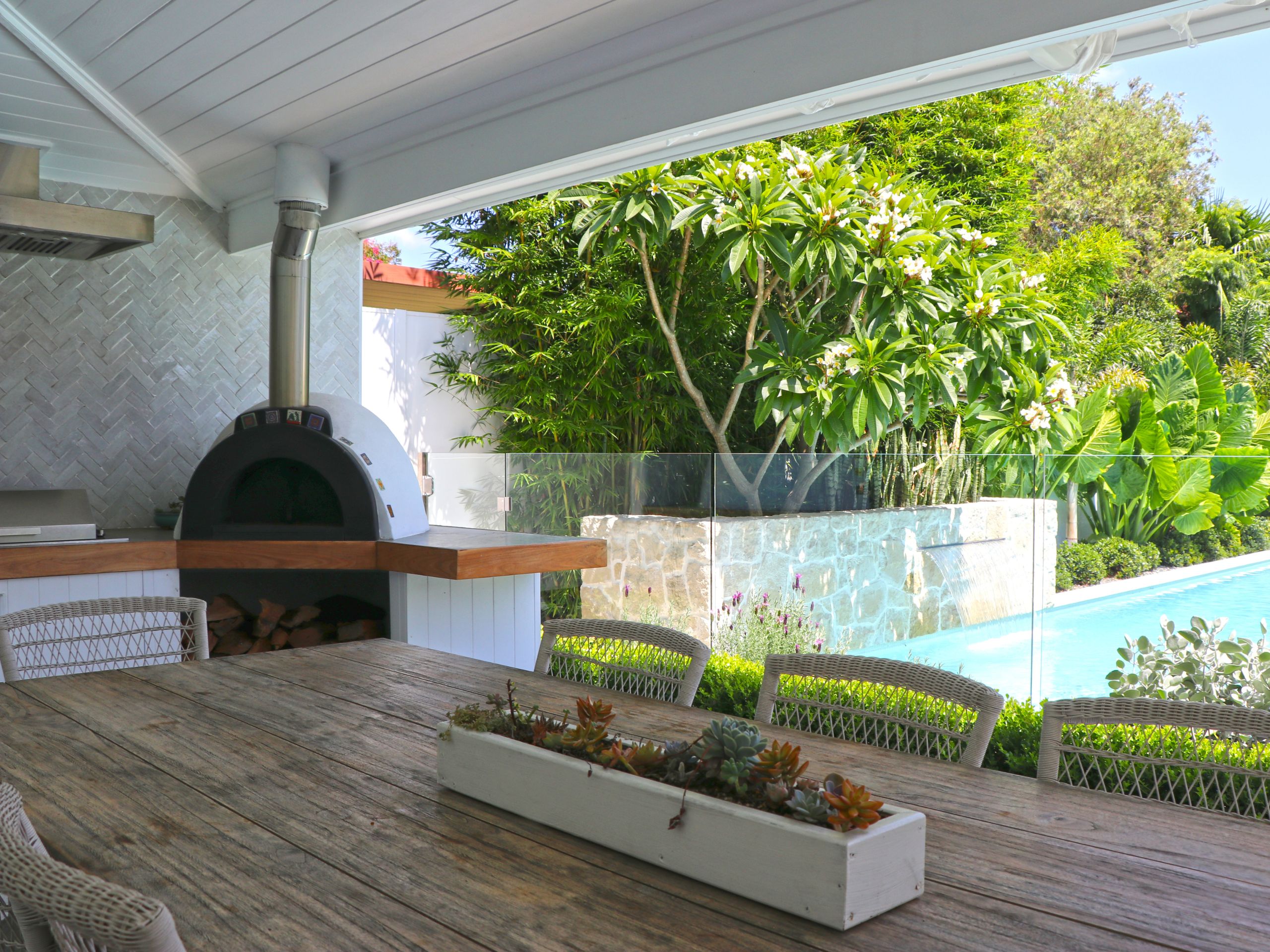 An outdoor kitchen is a popular pool area idea