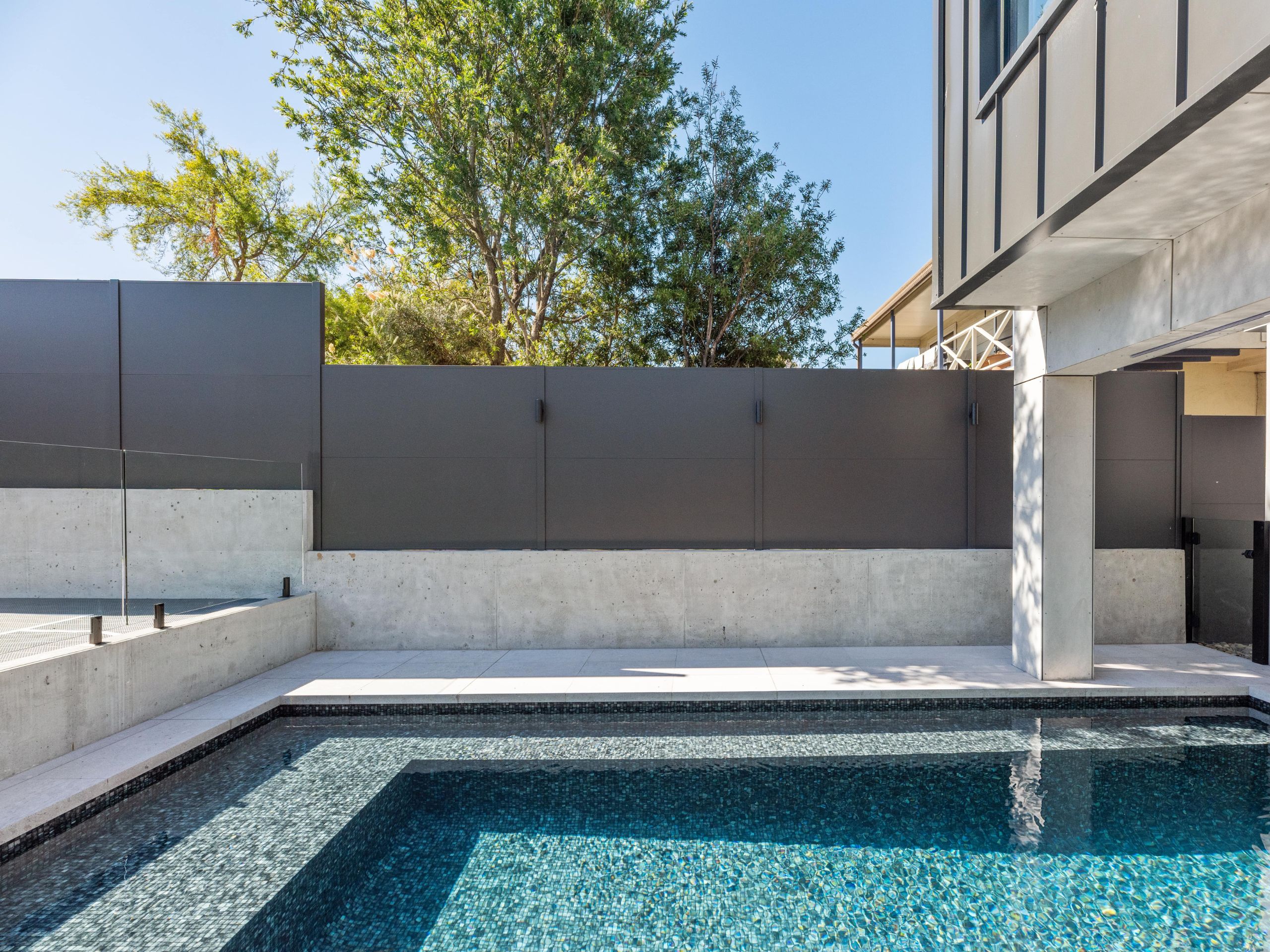 A minimalist colour palette and geometric shapes are a winner for pool area ideas