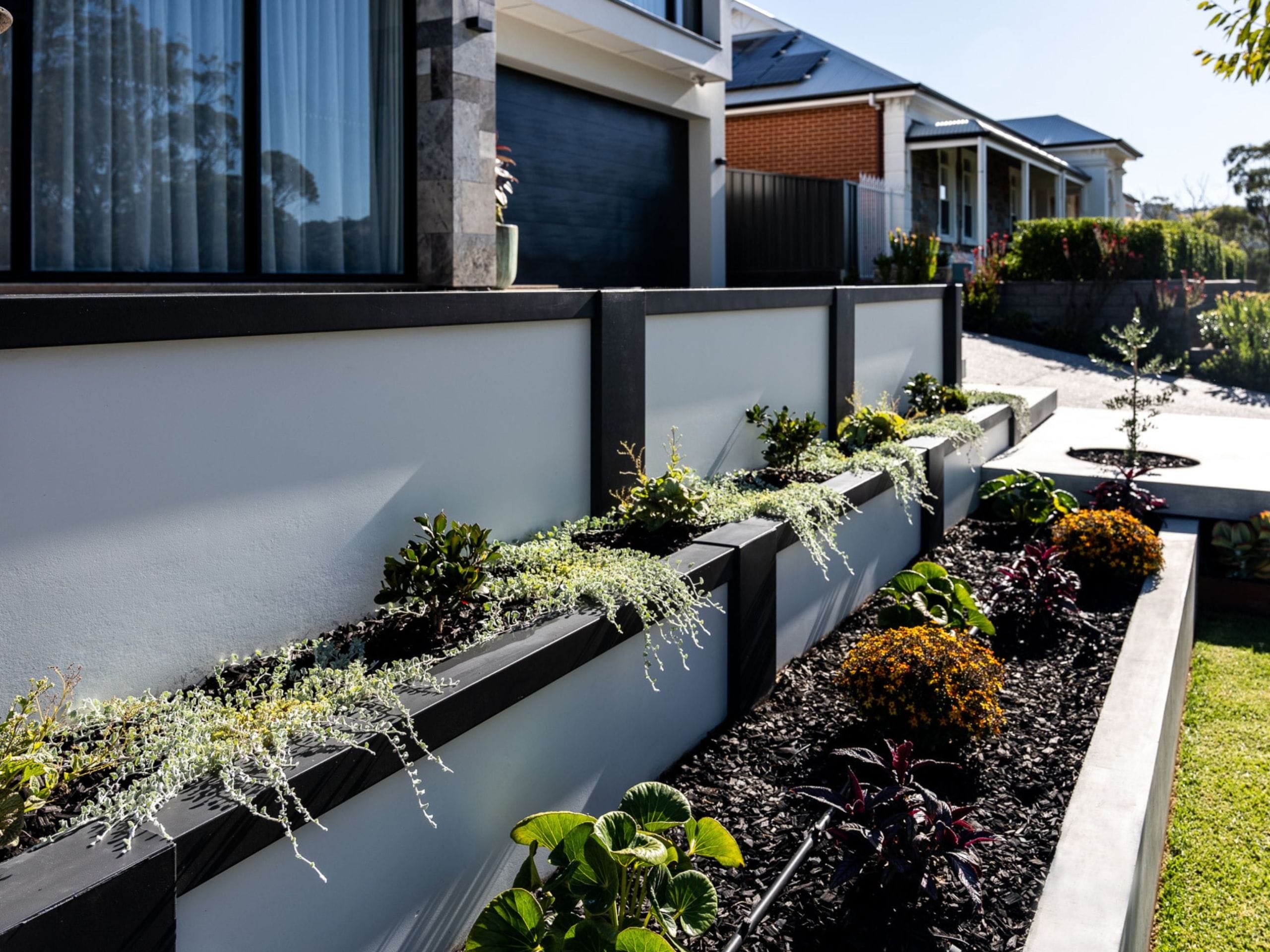 A retaining wall elevates landscaping and provides a feature and focal point for outdoor design