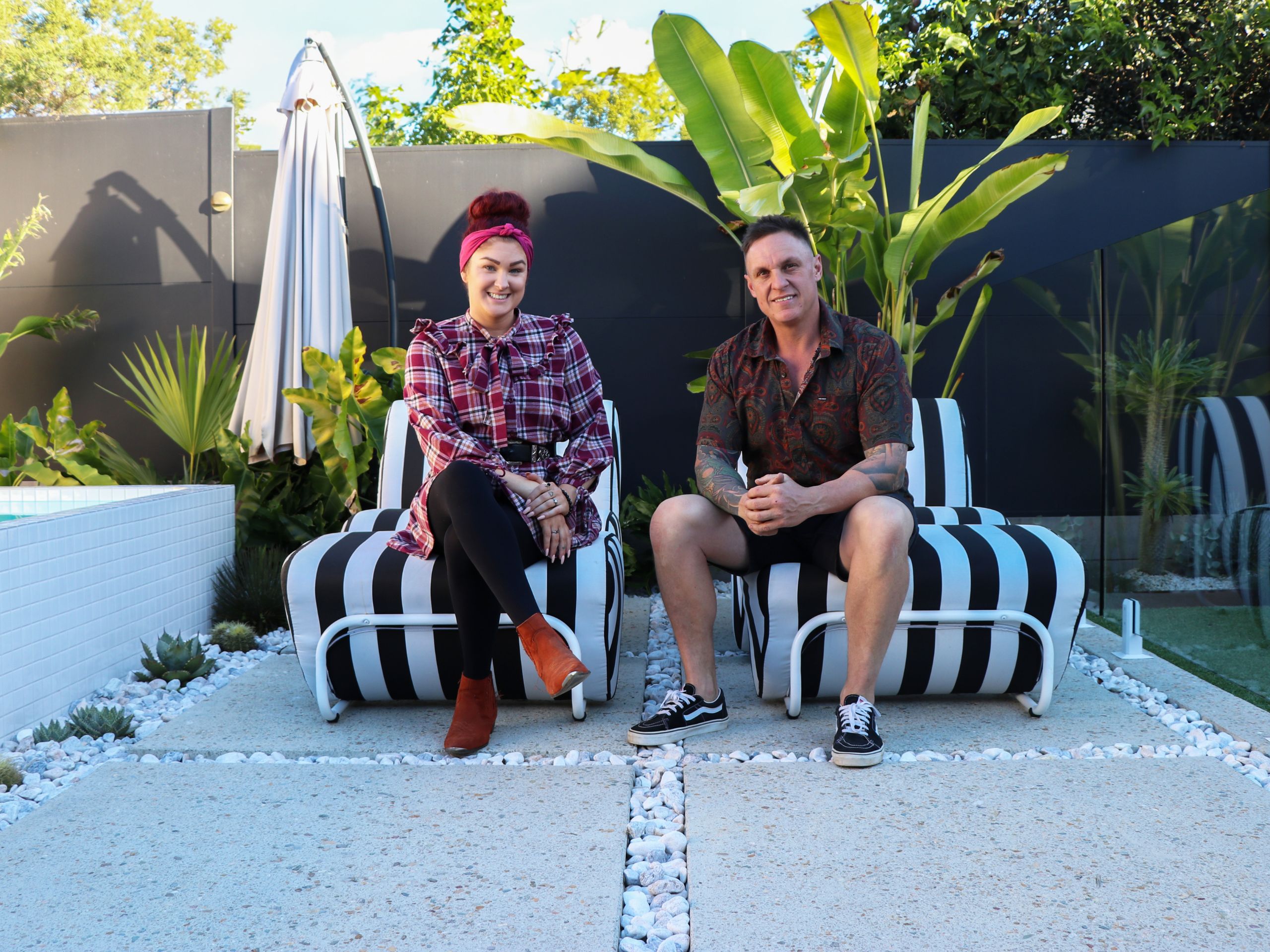 Jimmy and Tam (The Block winners 2020) in front of their TrendWall boundary fence at their QLD home.