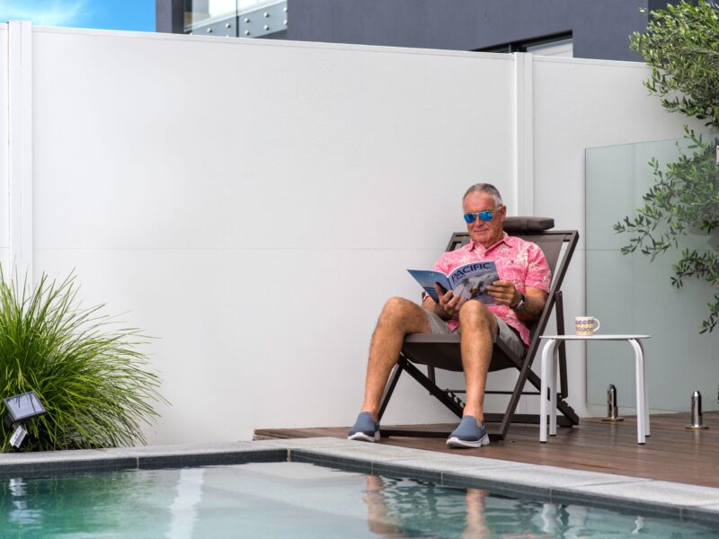 Man sits infront of a SlimWall reading a magazine