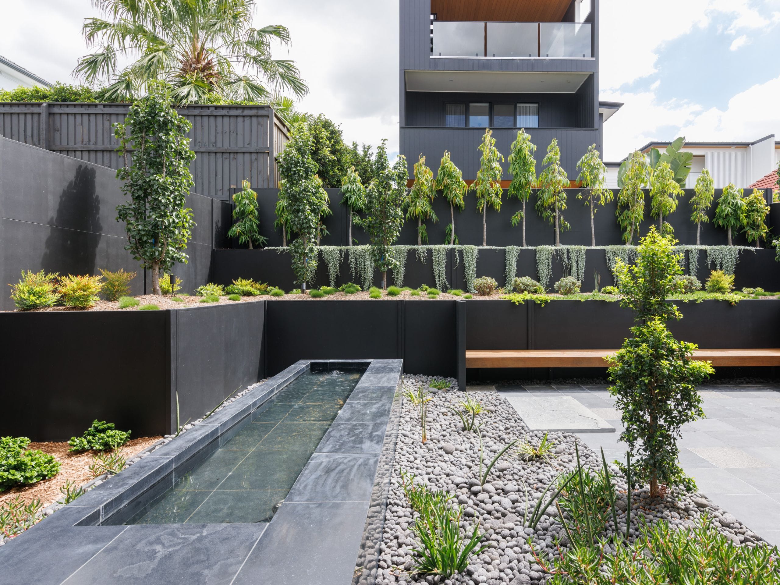 Greenery and manicured landscaping is a functional backyard privacy solution