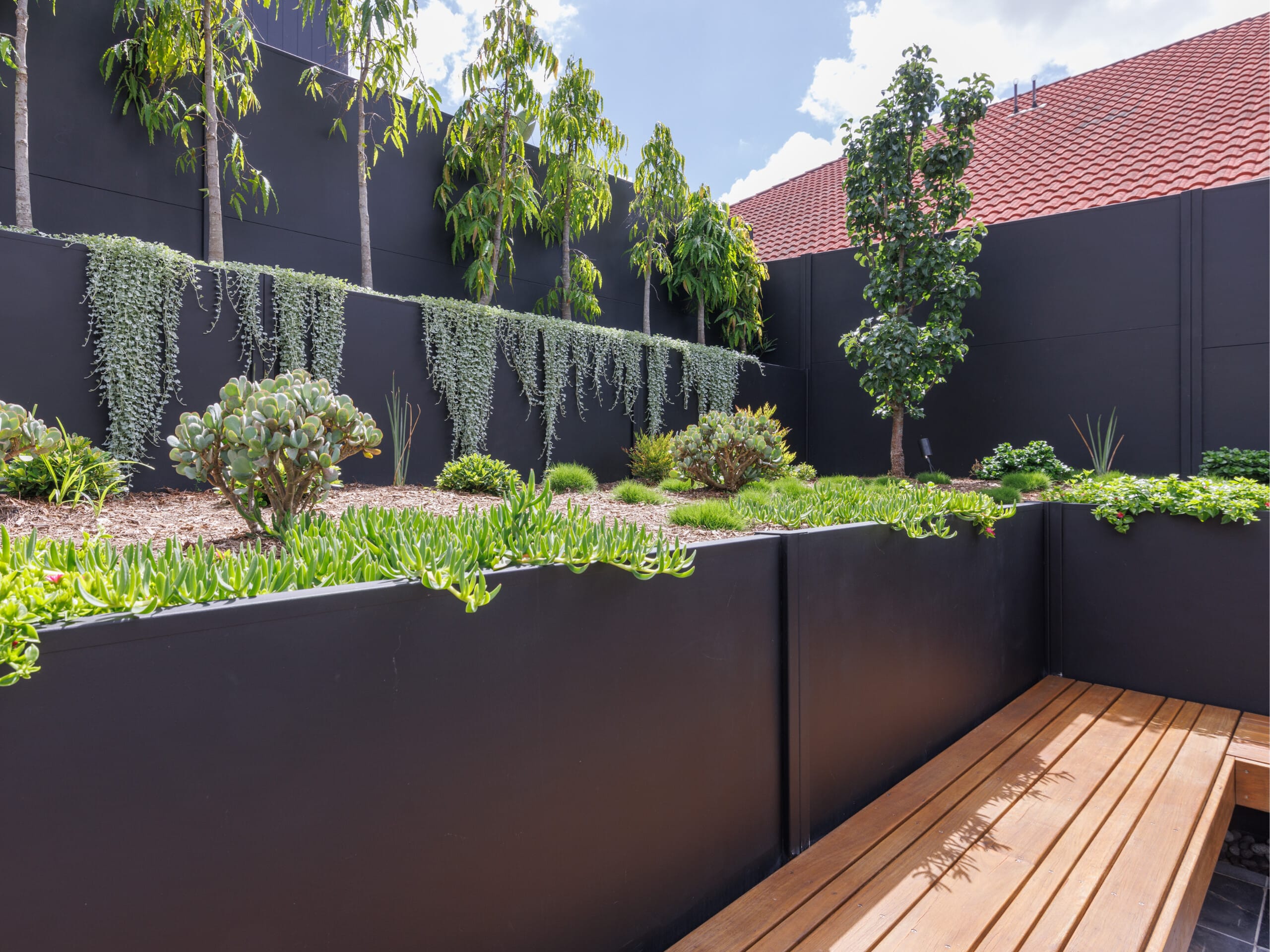 A retaining wall is a good way to level sloping ground or maximise usable space