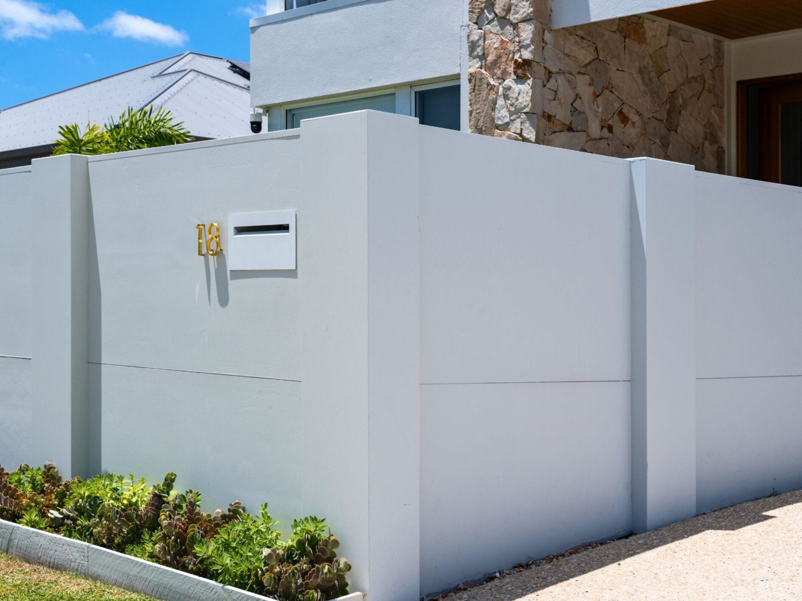 Keep the front boundary sleek by integrating functional elements like a recessed letterbox into a clean EstateWall.