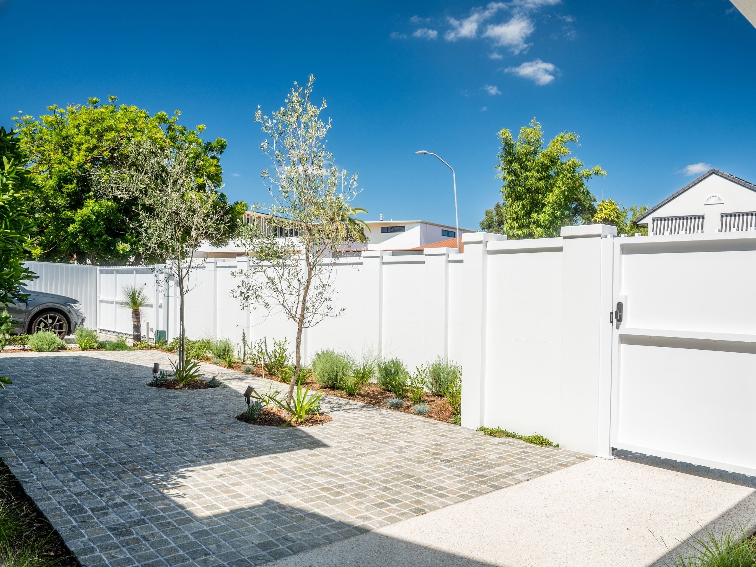 A grand EstateWall front wall is the ideal complementary fence for this landscaping renovation