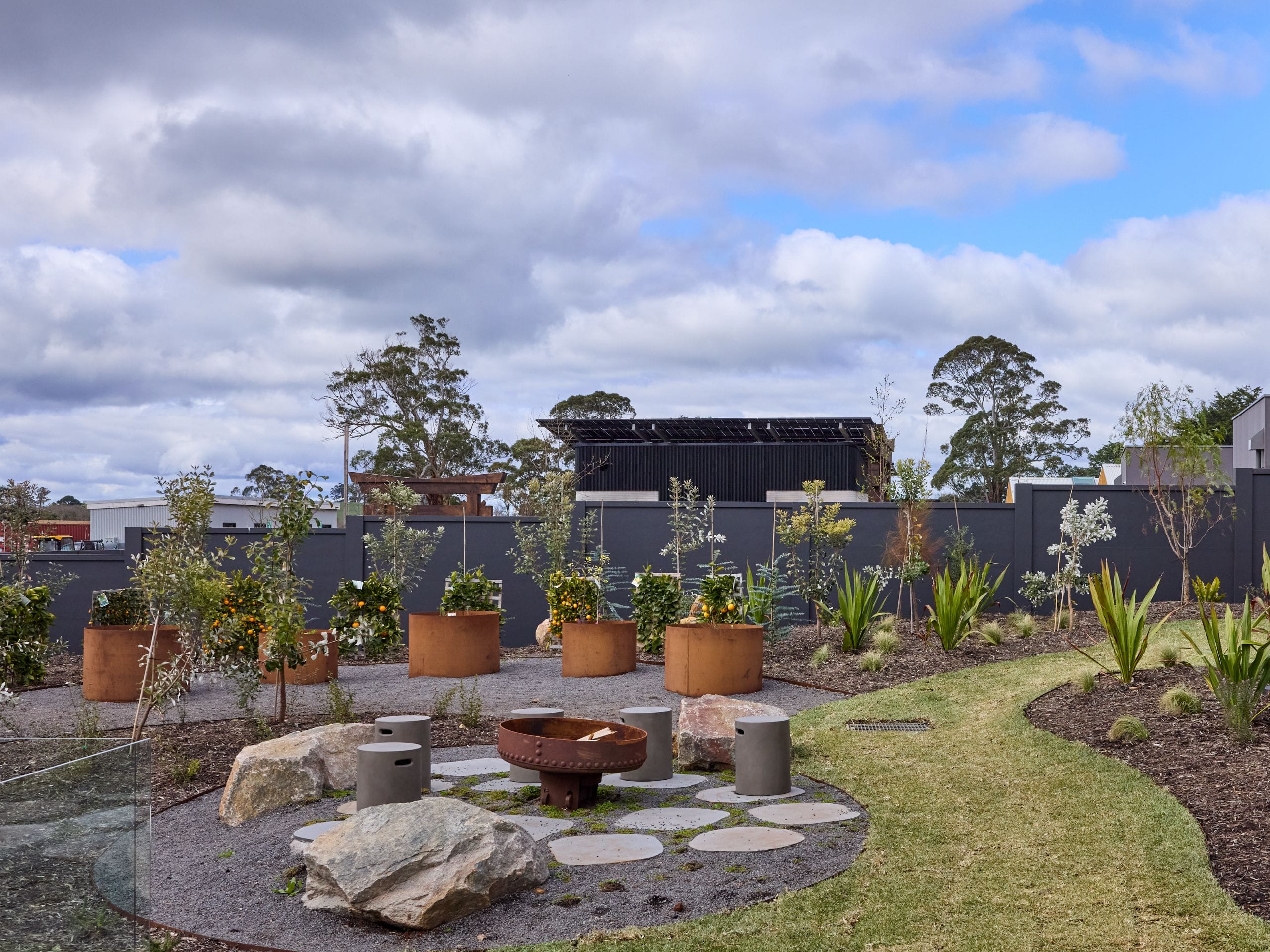 A successful outdoor fire pit isn't designed in isolation. It should feel connected to the rest of your backyard and complement existing features.