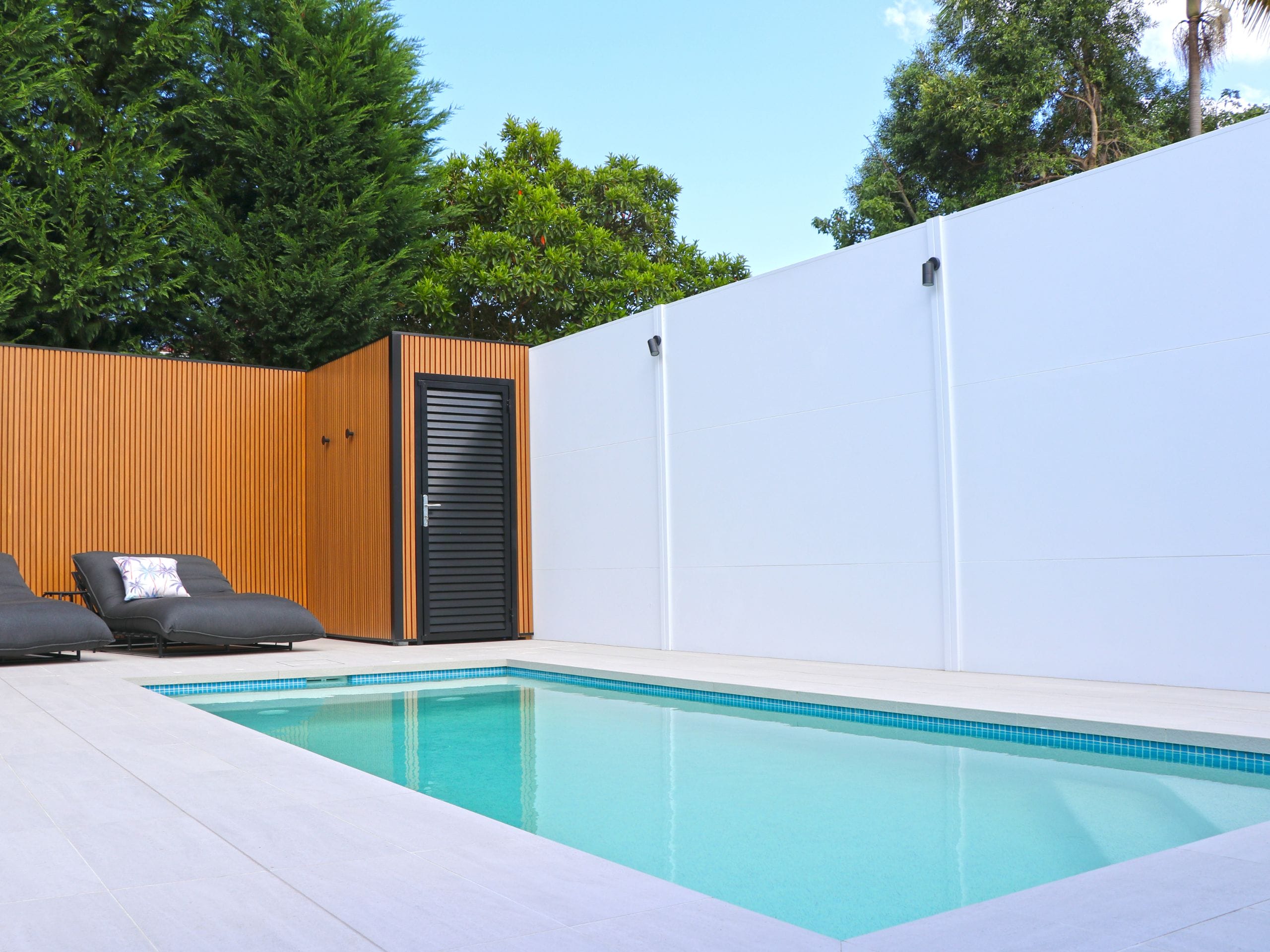 Mixing materials is a simple way to add interest to a swimming pool feature wall.