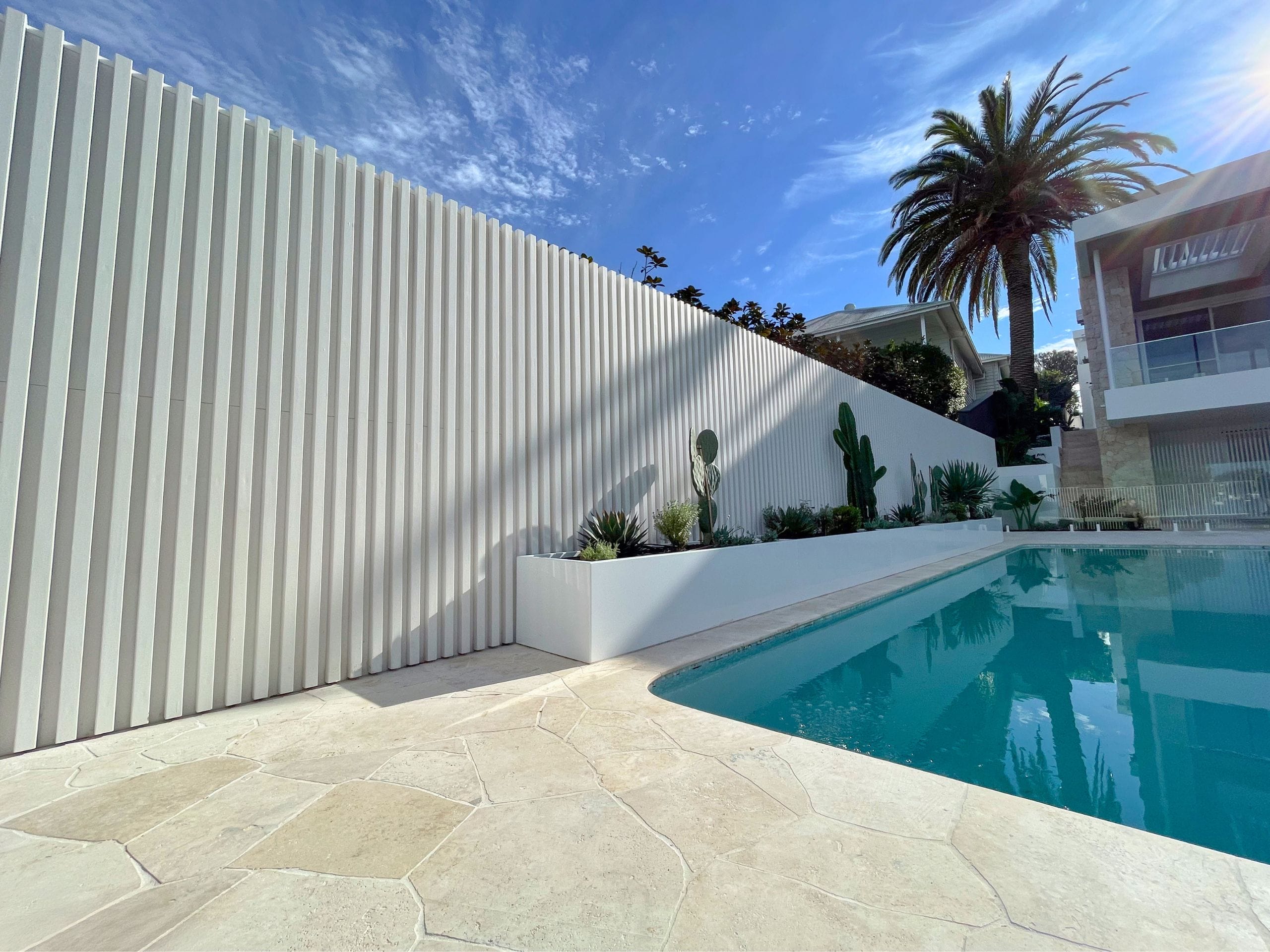 At this coastal-contemporary home, white aluminium battens have been fixed to TrendWall® to create a striking textured effect.