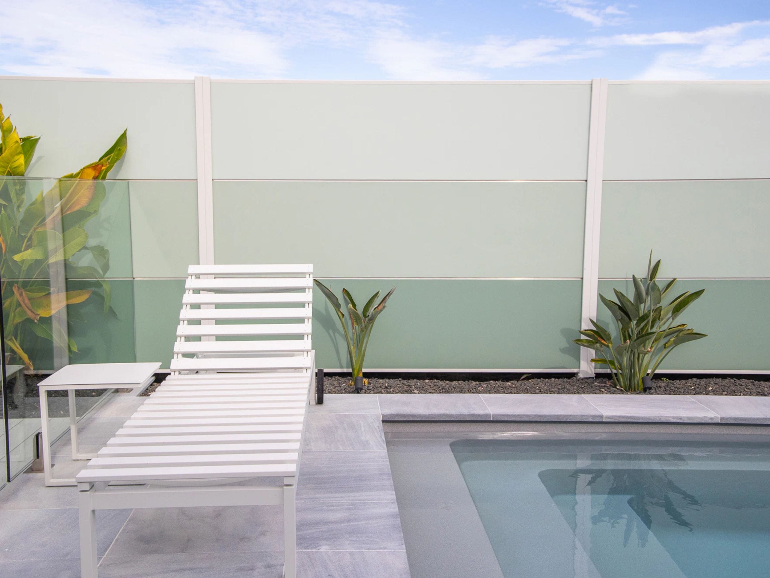 For their DIY backyard renovation, the Dawson family transformed a SlimWall® into a colourful backdrop for their pool.
