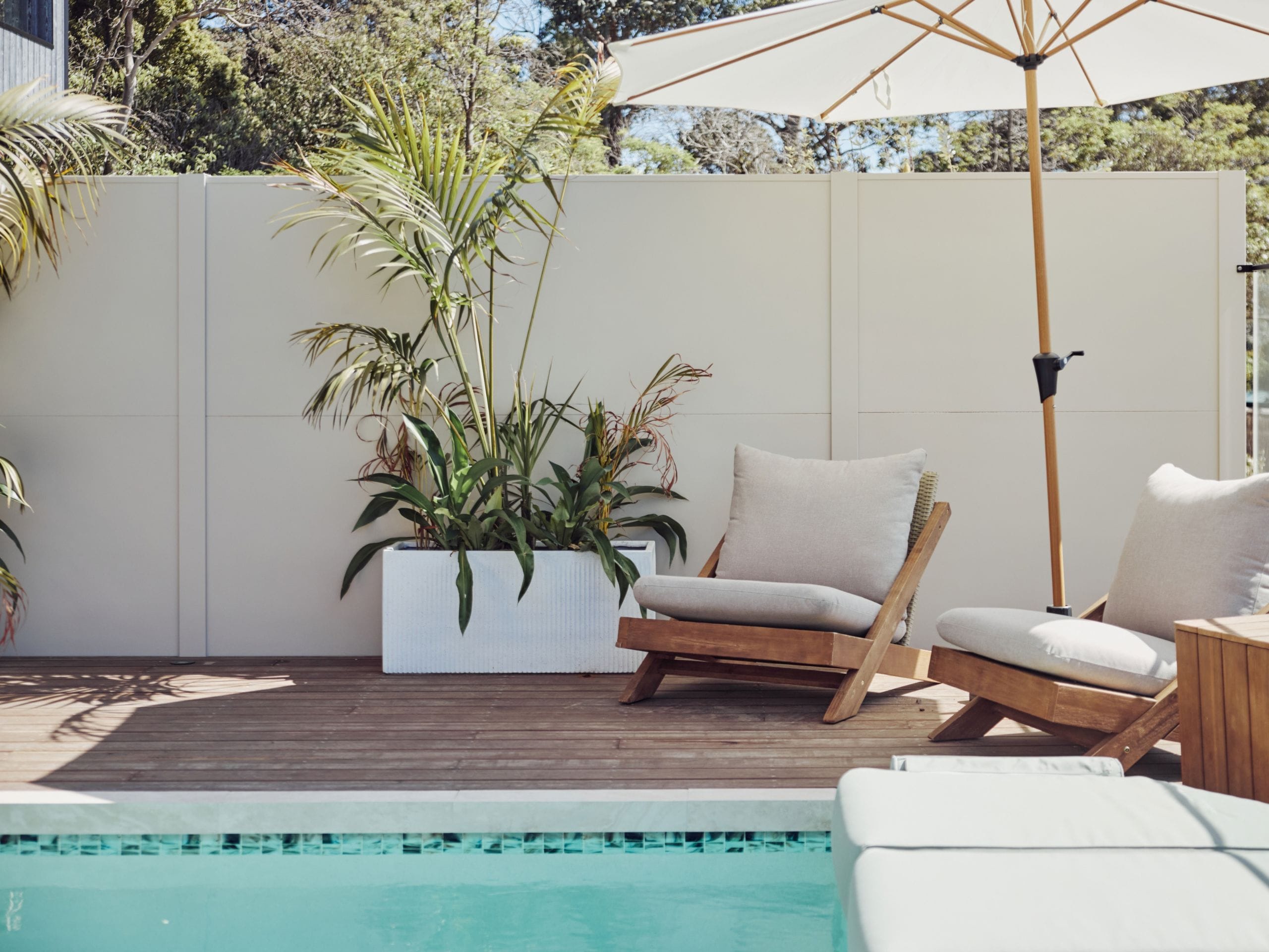 Textured plaster, tactile fabrics and layered finishes bring softness to the season’s interiors. The same approach can make an outdoor area feel welcoming rather than stark. 